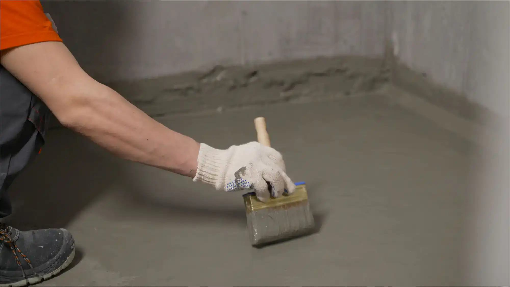 Technician applying basement waterproofing sealant to foundation wall in Montgomery County, Pennsylvania