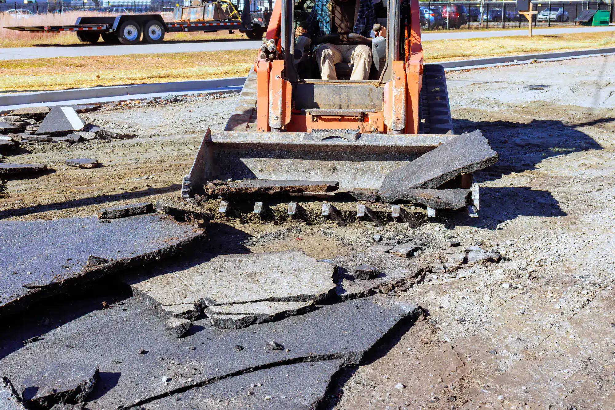 Bulldozer breaking up asphalt at a worksite in Montgomery County, Pennsylvania