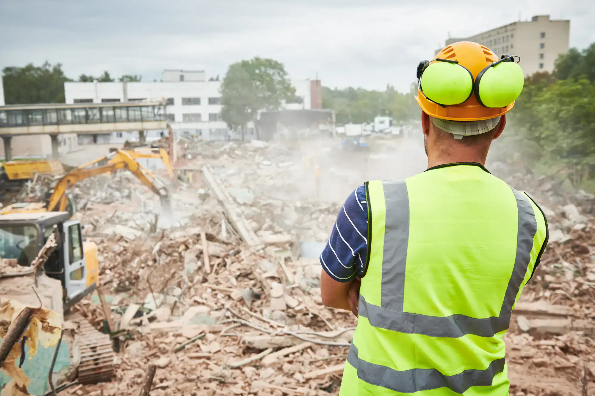 Construction site demolition worker in Montgomery County, Pennsylvania removing debris during a controlled structural teardown