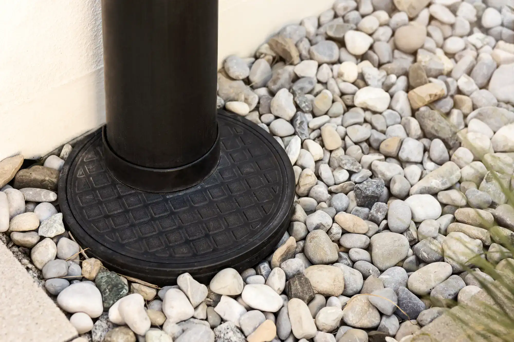 Downspout stone drainage system installed along home foundation in Montgomery County, Pennsylvania to help direct rainwater away from the property